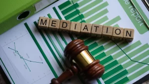 Mediation spelled out in block letters on top of a bar graph paper