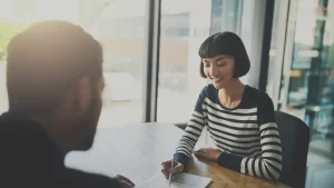 a personal injury lawyer explaining to their client what happens after mediation settlement